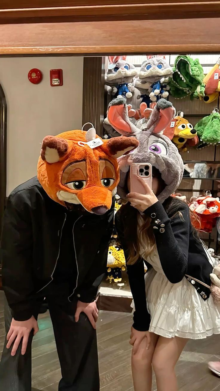 A playful couple trying on character hats